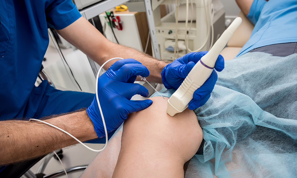 Doctor using tubes and ultrasound for radiofrequency catheter ablation