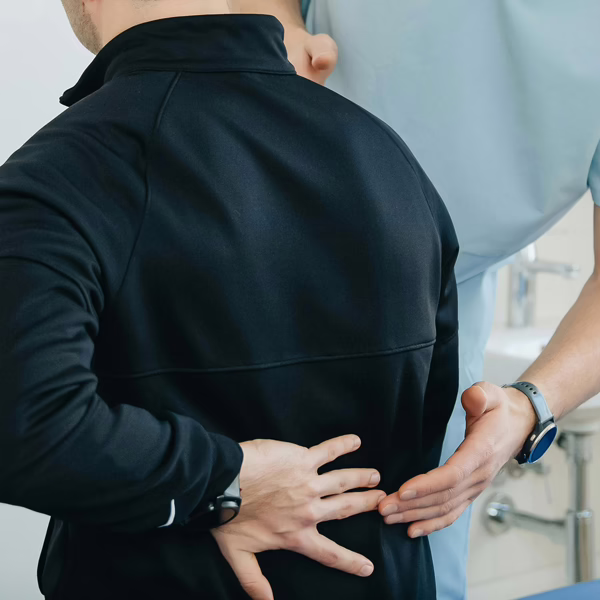 Doctor examining a patient for back pain